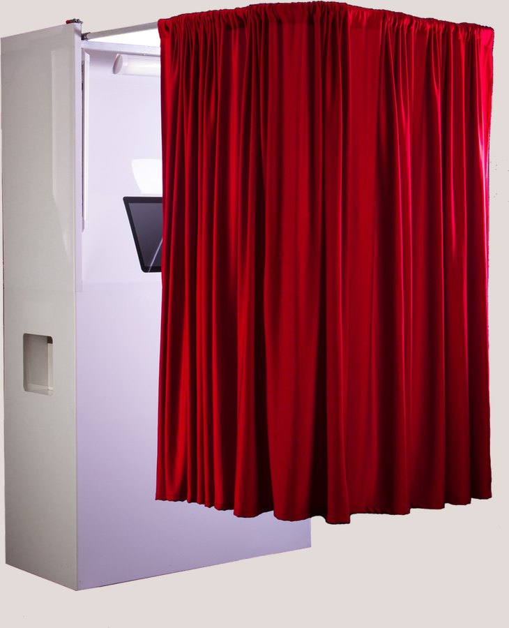 The MemoryBooth photo booth: a white lacquer cabinet with a red velvet curtain drawn across the opening